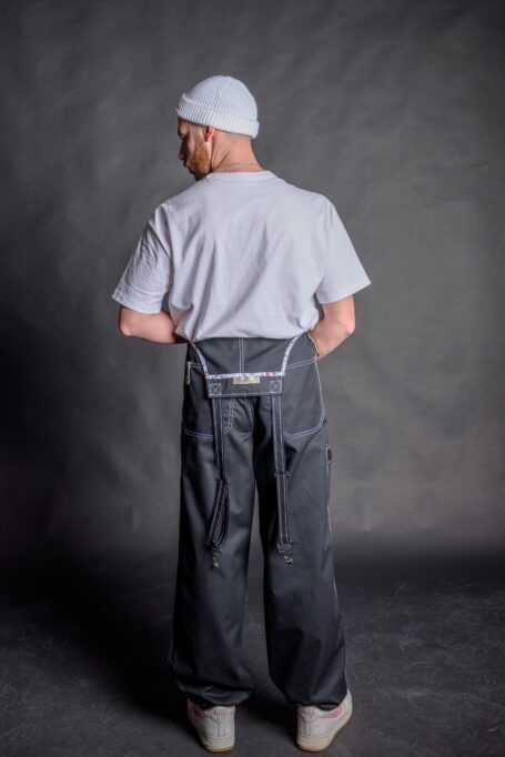 Bartender wearing stylish, breathable and durable black overall pants with his white t-shirt.